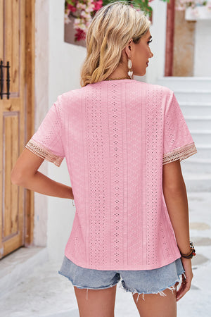 Blush pink eyelet blouse with lace trim on short sleeves and V-neck.