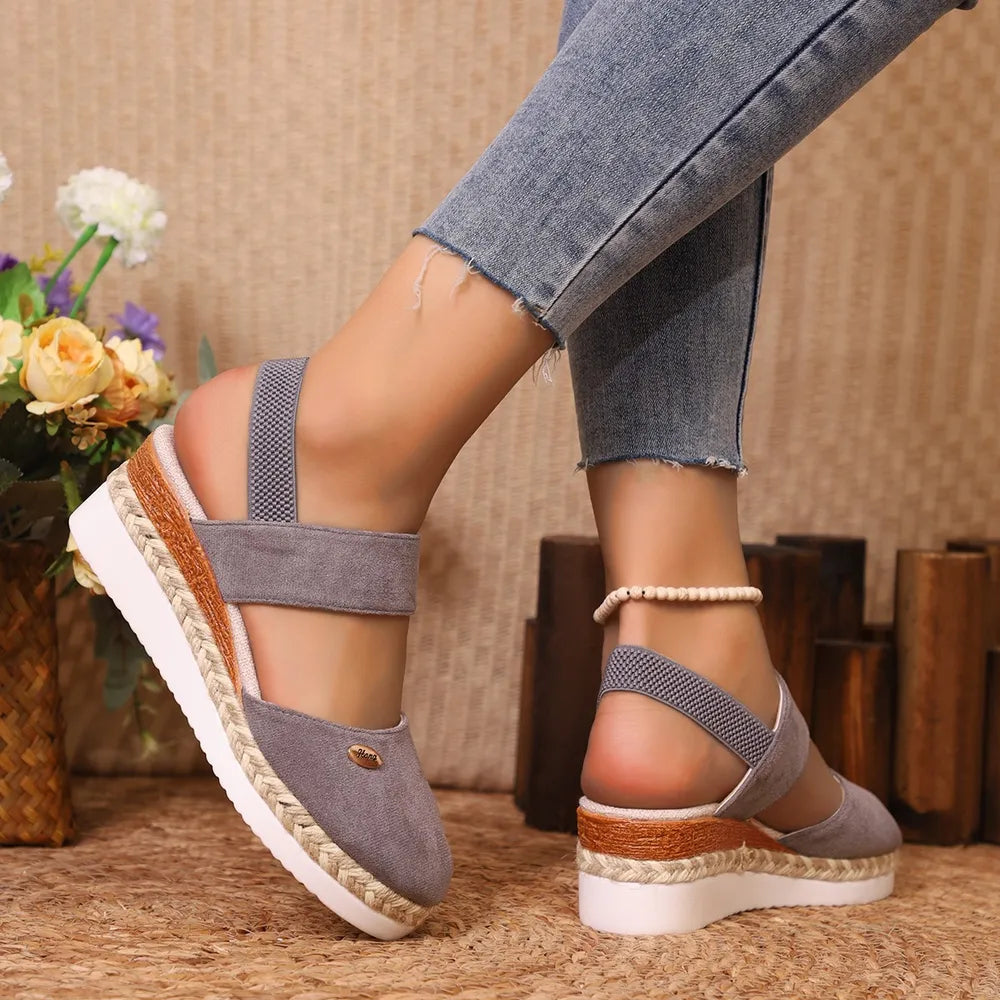 Gray espadrille wedge slingback sandals with elastic straps and braided jute detail.