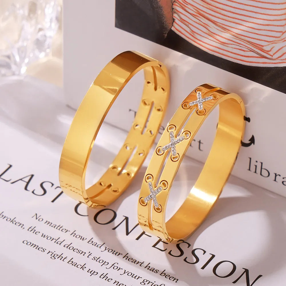 Gold cuff bracelets, one plain, one with diamond laced detail.