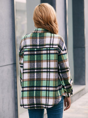 Oversized green plaid flannel shacket with buttoned cuffs and collar.