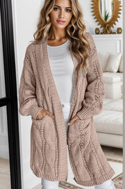 Camel cable knit open-front cardigan with pockets and openwork details.