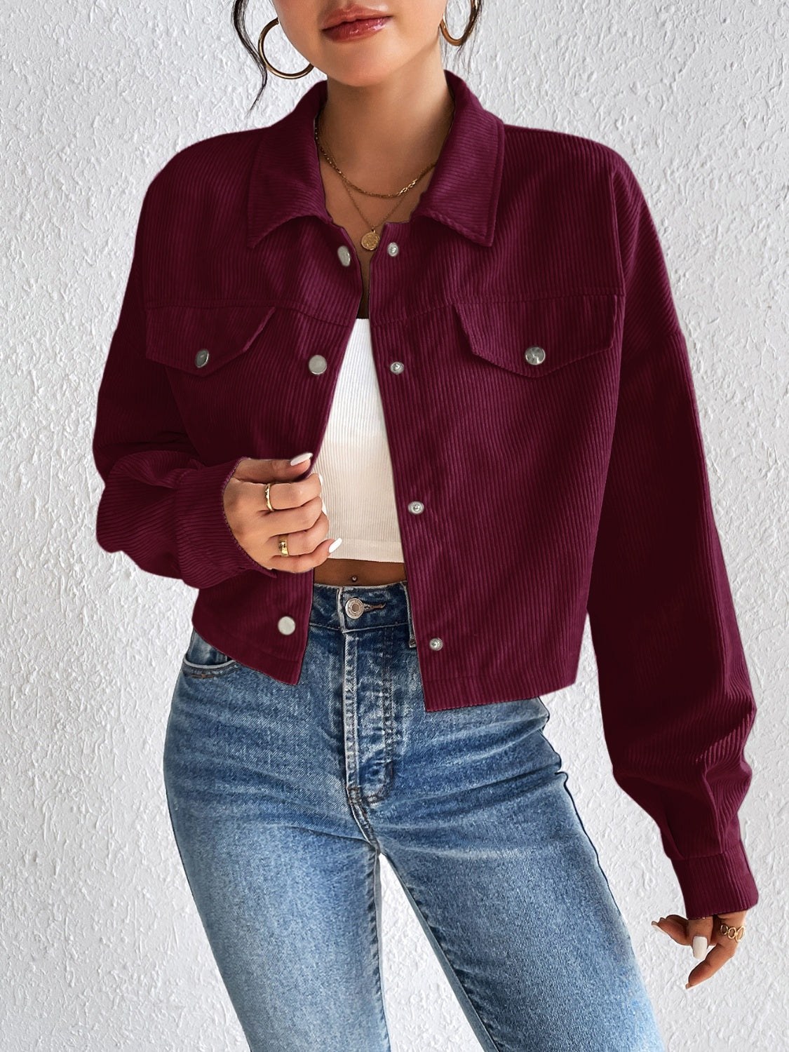 Burgundy corduroy cropped jacket with snap front and chest pockets.