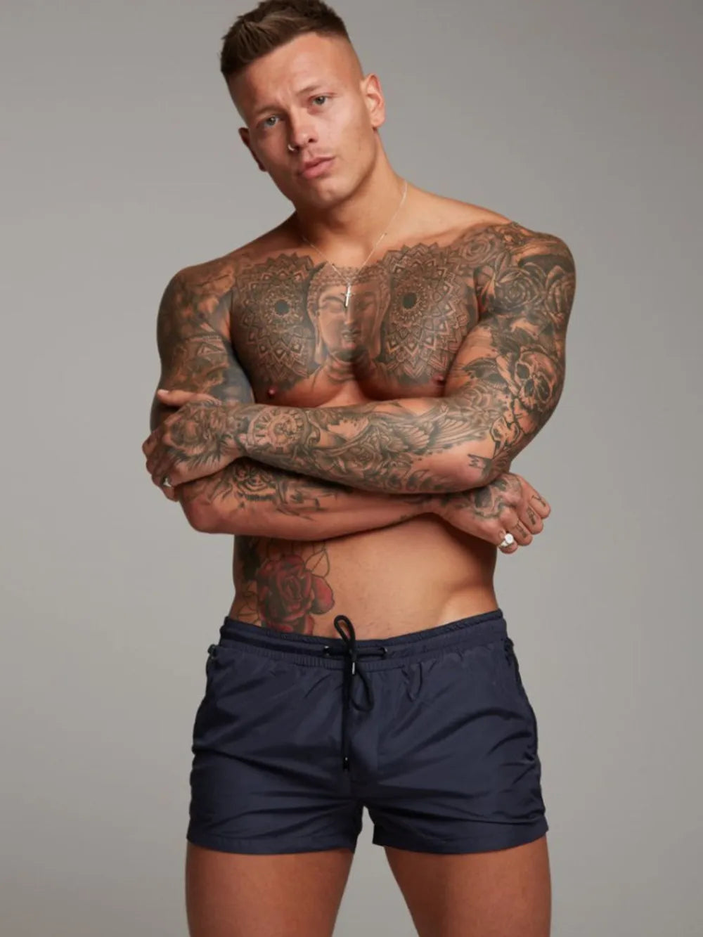 Navy boardshorts with drawstring and zip pocket detail.