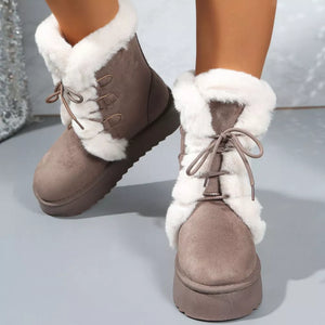 Brown suede lace-up ankle boots with white faux fur trim and platform sole.