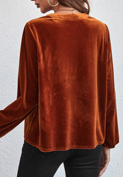 Gathered velvet henley blouse in brown with long sleeves.
