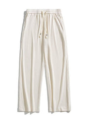 Men's ivory drawstring wide leg sweatpants with vertical ribbing.