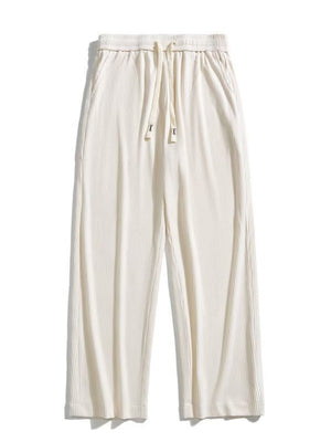 Men's ivory drawstring wide leg sweatpants with vertical ribbing.