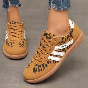 Leopard print walking sneakers with white stripes and brown soles.