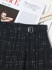 Black plaid mini skirt with ruched detail and a black belt with silver buckle.