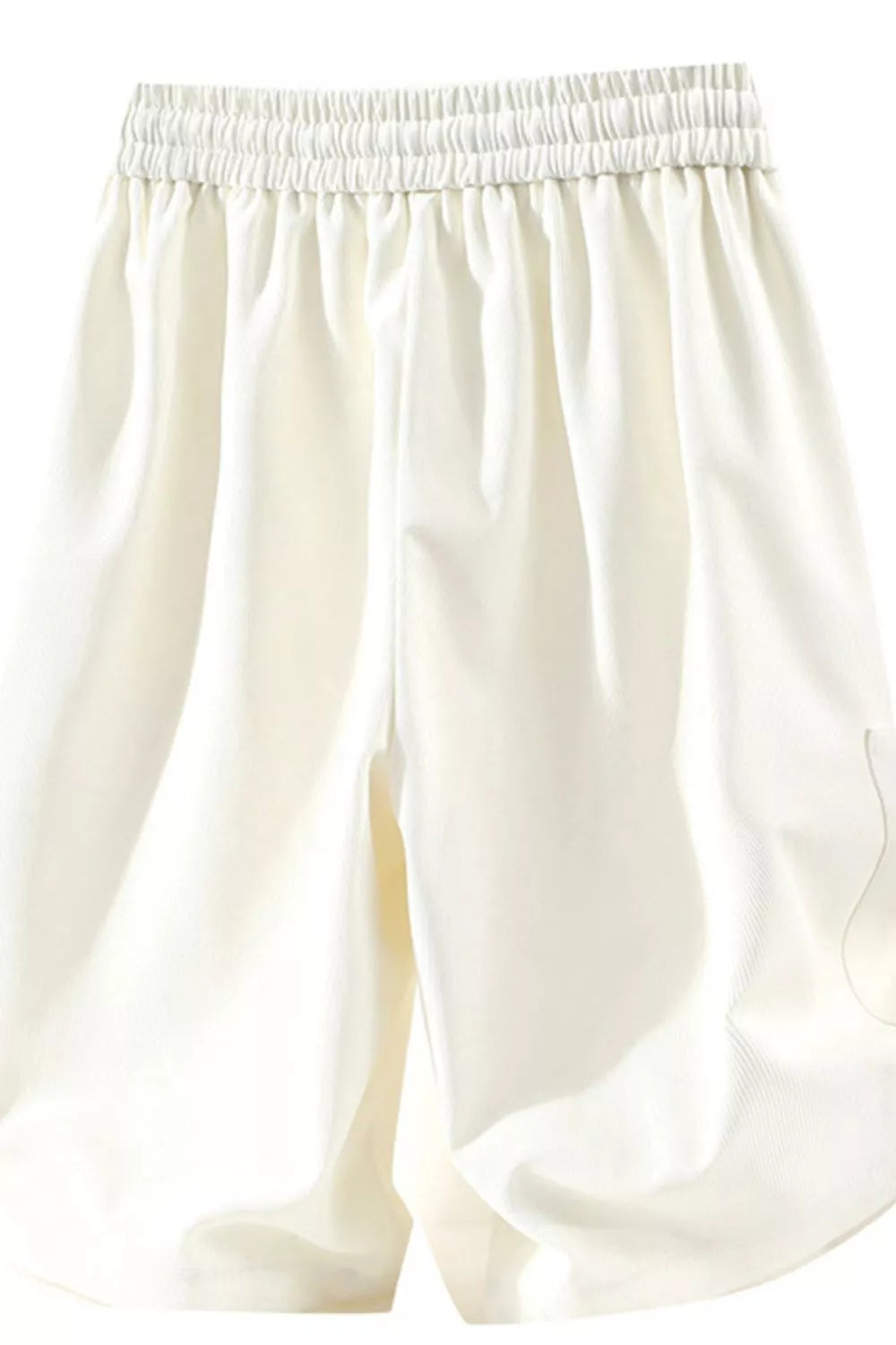 Relaxed fit ivory chino shorts with elastic drawstring waist and pockets.