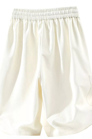 Relaxed fit ivory chino shorts with elastic drawstring waist and pockets.