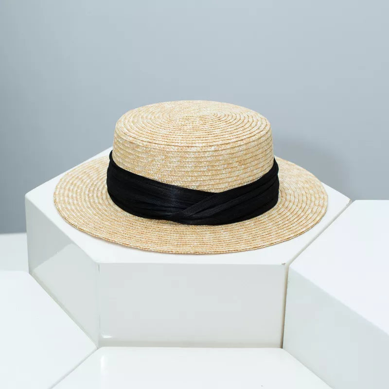 Straw boater hat in tan with black ribbon trim