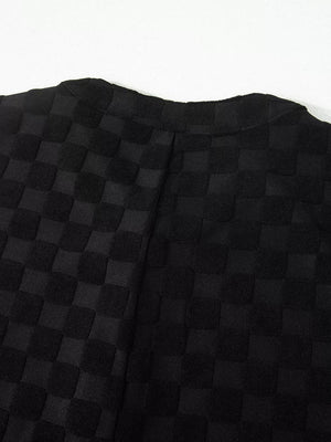 Black checkered wide-leg jumpsuit with button-front detail.