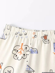 Children's cream sleepwear set with playful cat and house print.