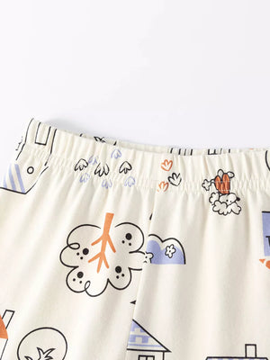 Children's cream sleepwear set with playful cat and house print.