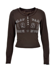 Brown long sleeve t-shirt with button neckline and white letter graphic.