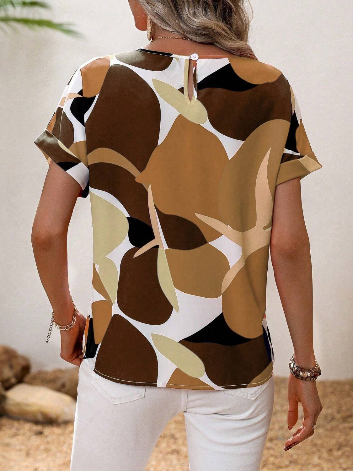 Women's abstract floral print tee in brown, camel, and black with short sleeves and a keyhole back detail.