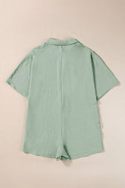 Sage oversized shirt romper with textured fabric and short sleeves.