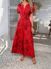Red geometric print wide-leg jumpsuit with V-neck and short sleeves.