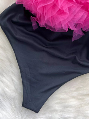 Black bodysuit with pink ruffled tulle detail and V-neck.