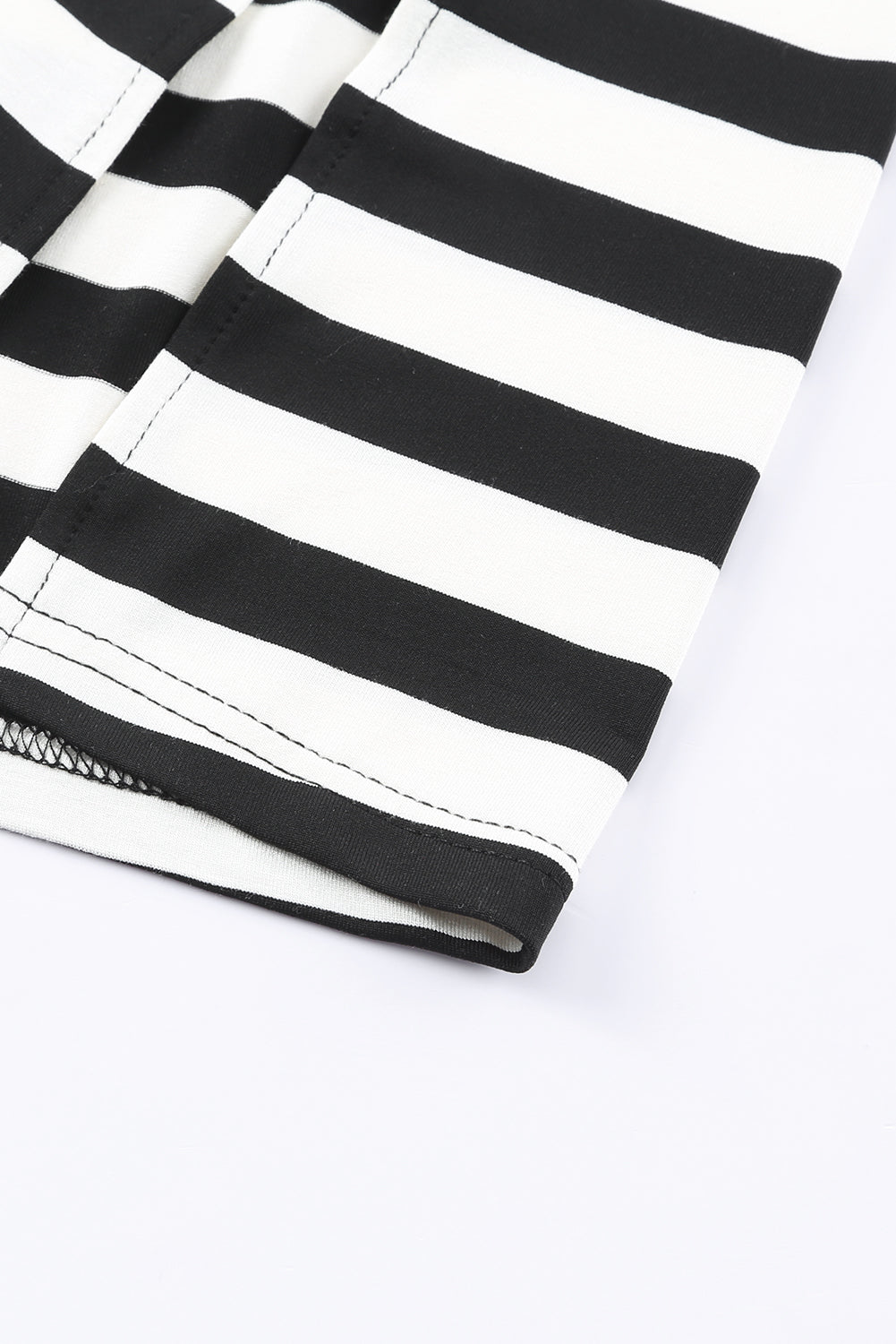 Black and white striped jersey maxi dress detail showing hem and stitching.
