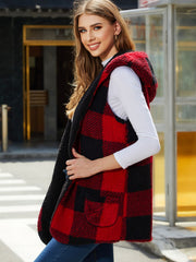 Reversible hooded vest in deep red and black buffalo check with fuzzy lining and pockets.
