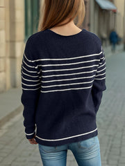 Dark blue ribbed knit crewneck sweater with white breton stripes and crew neckline.