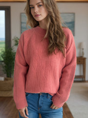 Textured knit raglan sleeve pullover in burnt coral with mock neck and diamond pattern.