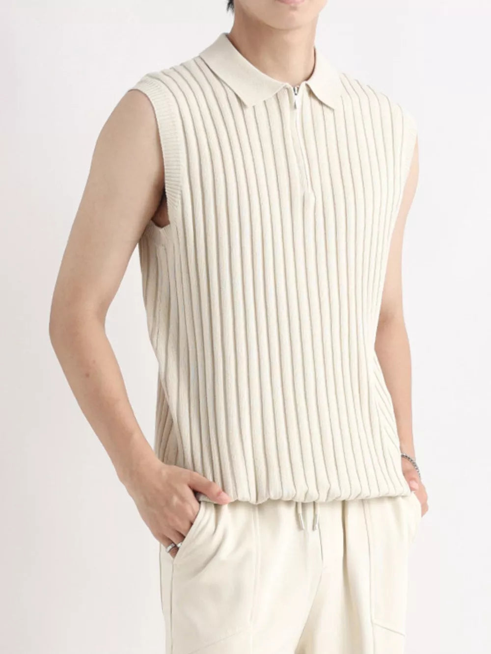 Apricot ribbed knit zip-up tank top with a collar and sleeveless design.