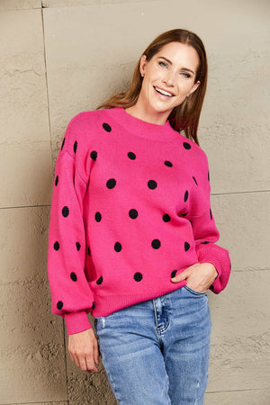 Hot pink polka dot knit sweater with balloon sleeves and crew neck.