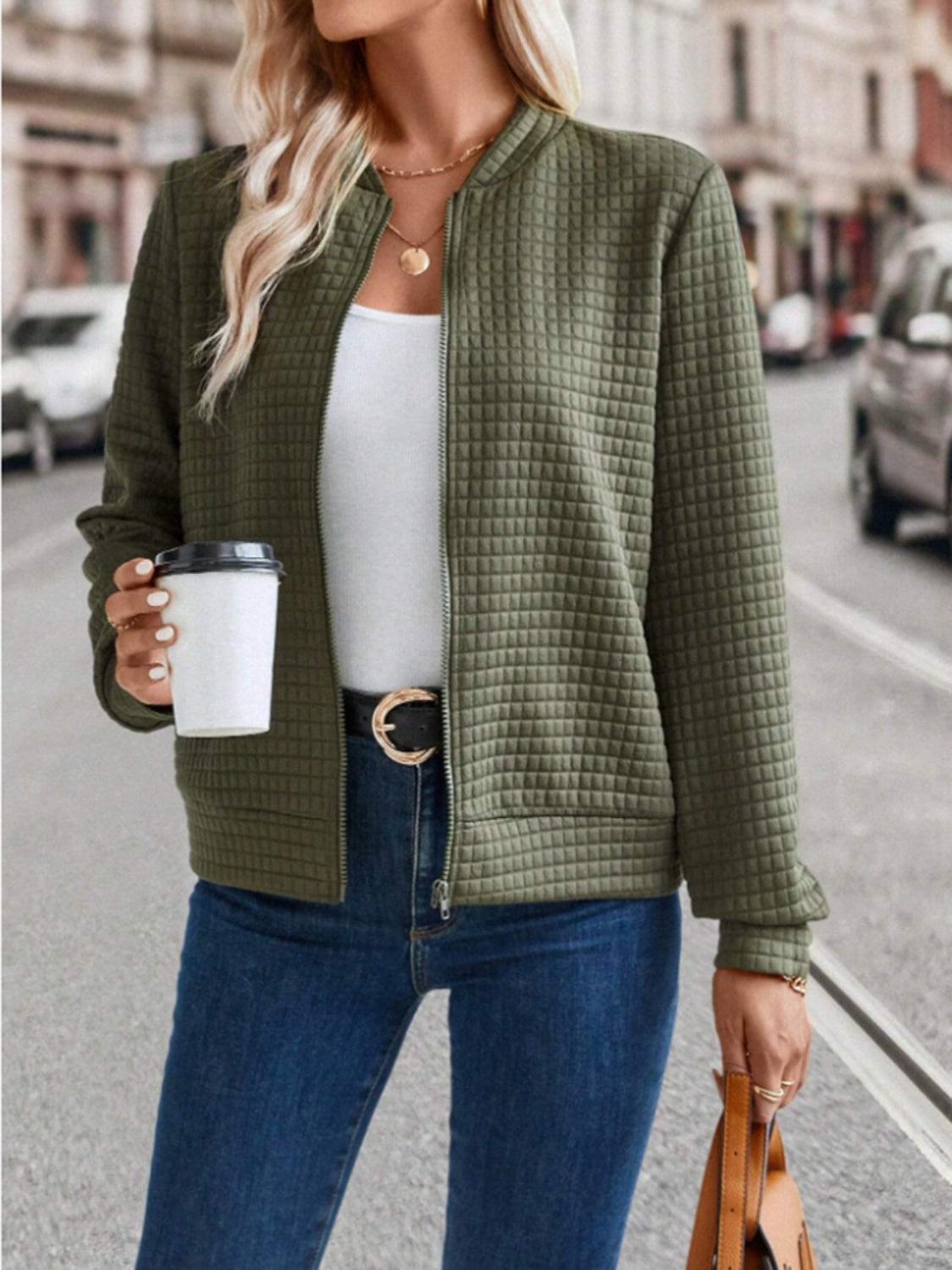 Army green quilted bomber jacket with zip closure and ribbed cuffs.