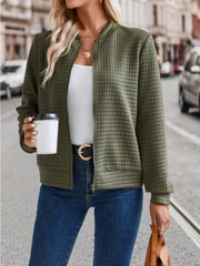 Army green quilted bomber jacket with zip closure and ribbed cuffs.