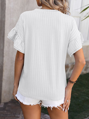 White textured blouse with flutter sleeves and a ribbed pattern.