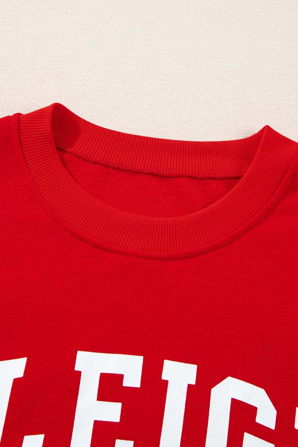 Red cotton crewneck sweatshirt with white "Sleigh" graphic detail.