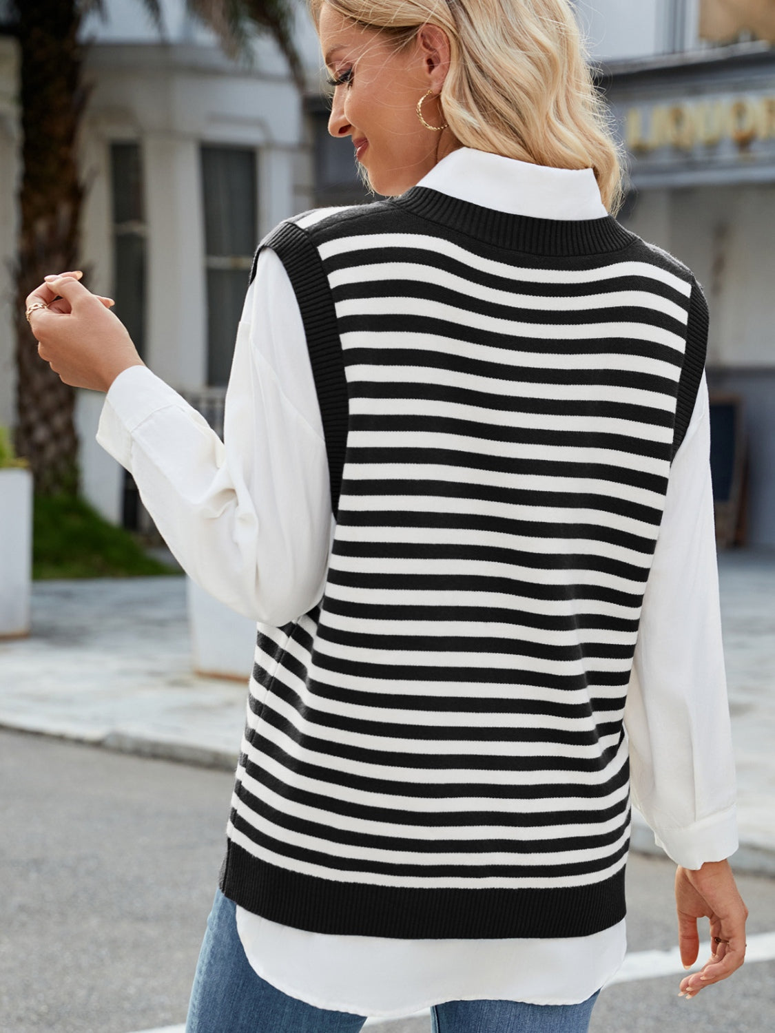 Striped knit v-neck vest in black and white acrylic with side slits.