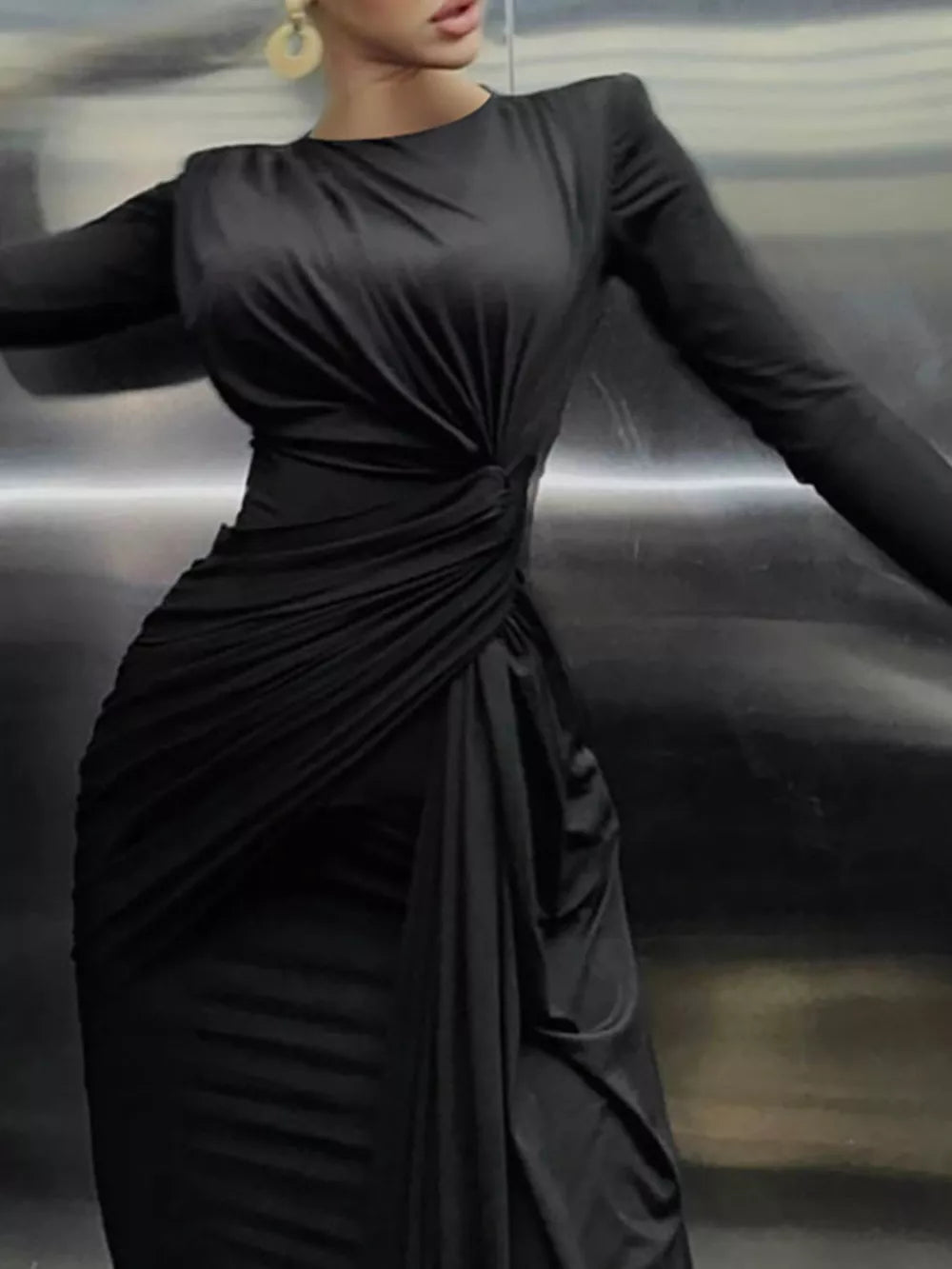 Black ruched long sleeve maxi dress with a boat neckline and bodycon fit.
