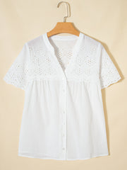 White cotton eyelet embroidered sheer shirt with short sleeves and button front.