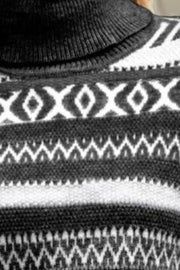 Geometric jacquard turtleneck sweater in black with diamond and zigzag patterns.