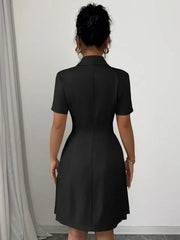 Black double-breasted pleated blazer dress with short sleeves and a collared neckline.