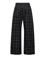 Plaid wide-leg men's sweatpants in black with white check pattern and drawstring waist.