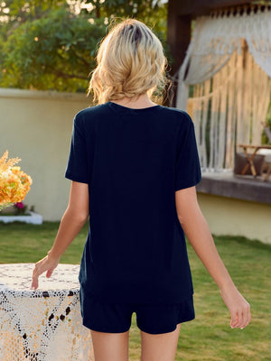 Dark blue loungewear set with V-neck top and shorts, puff sleeves visible.
