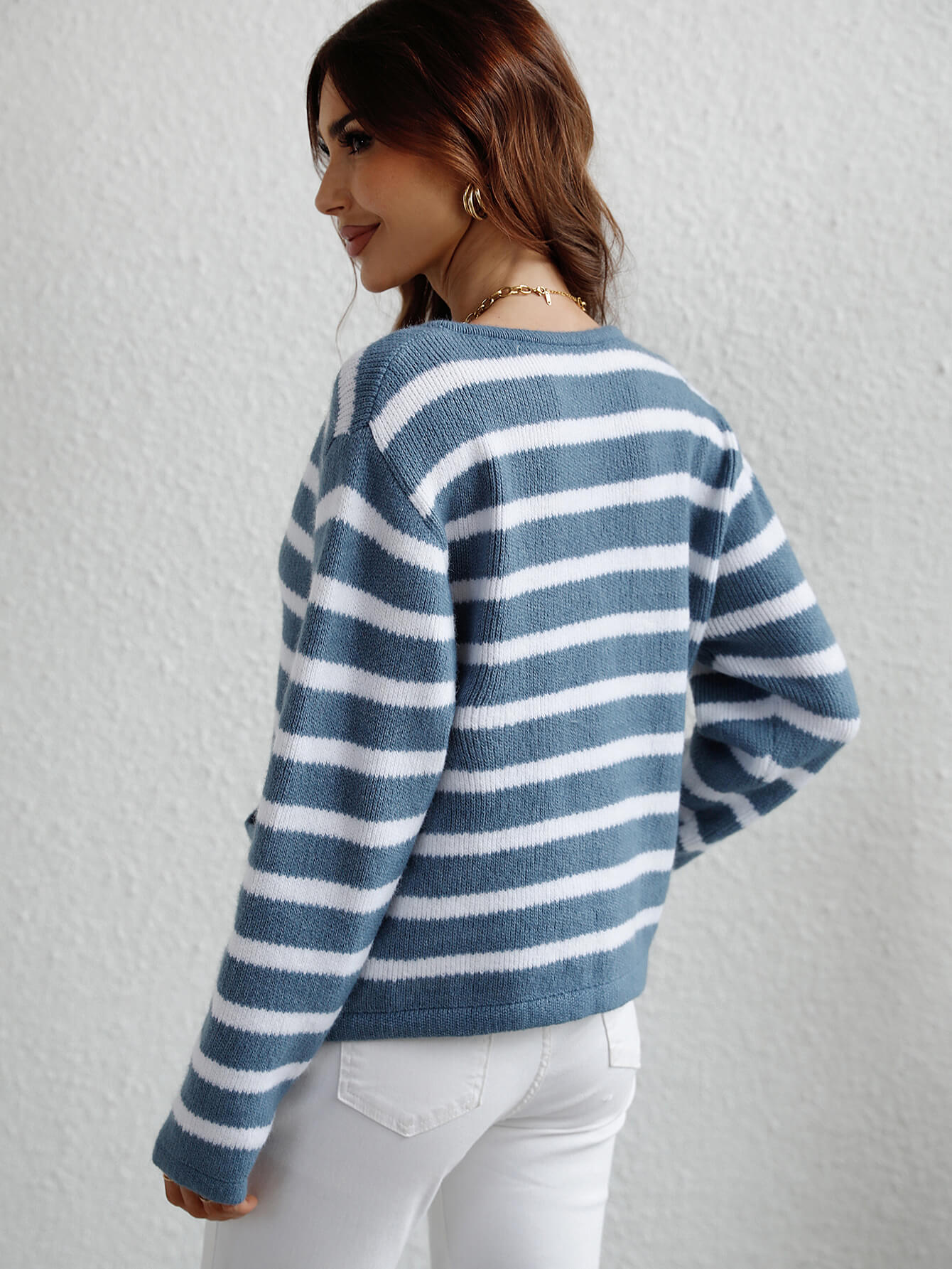 Horizontal stripe knit cardigan with pockets in blue and white, crew neck, long sleeves.