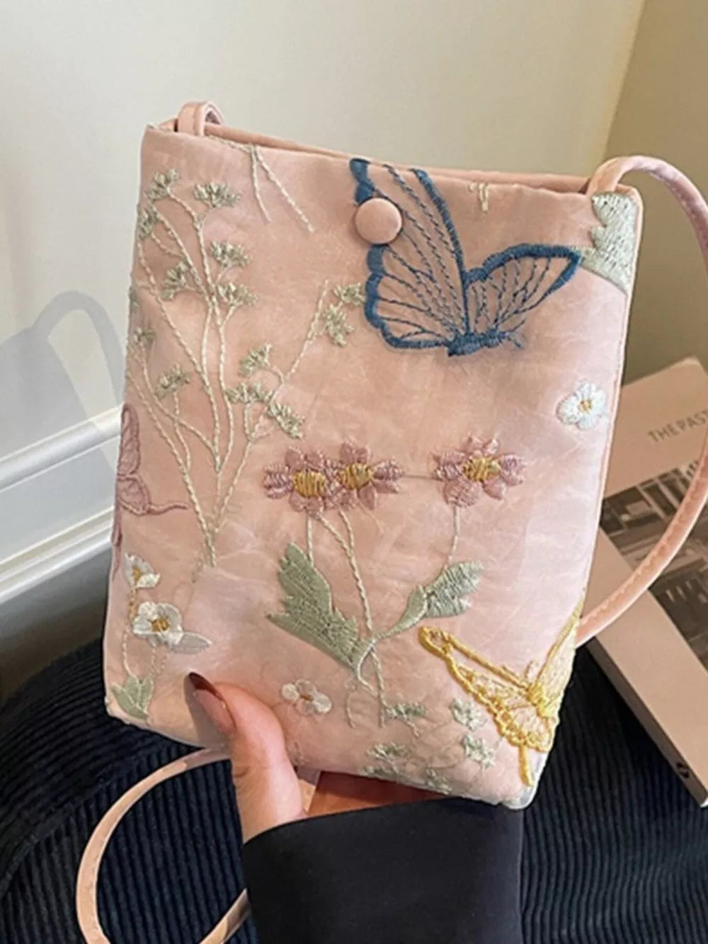 Pink embroidered mini crossbody bag with butterfly and floral details