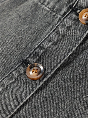 Gray faded denim pinafore dress with button details and pockets.