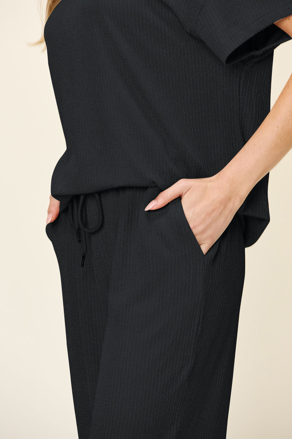 Black waffle knit lounge set with drawstring waist and pockets.