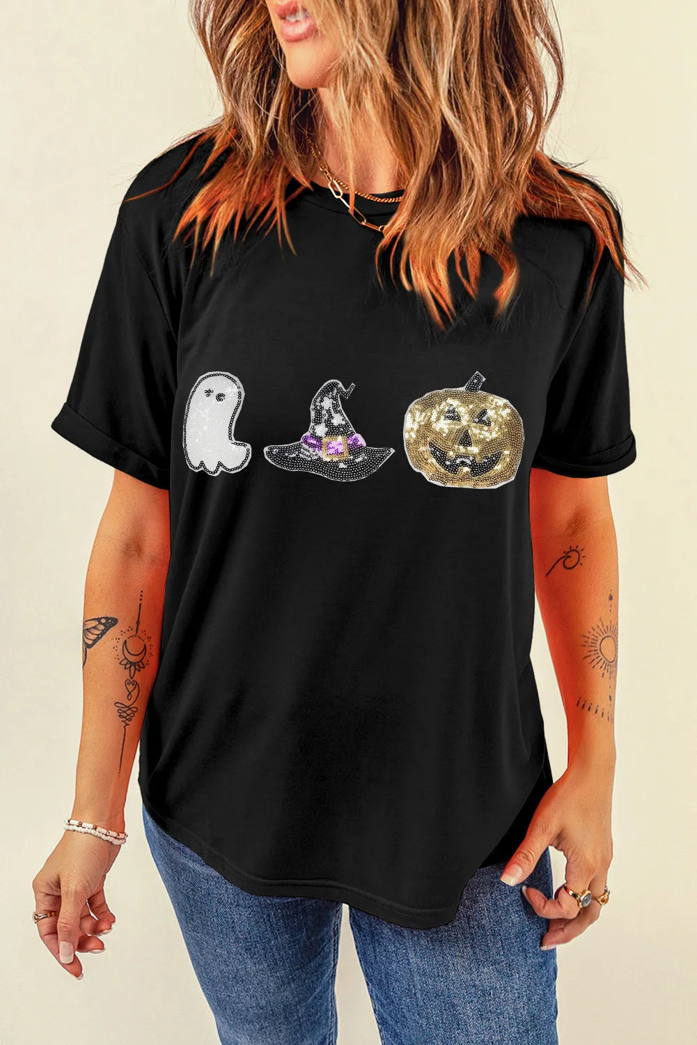 Black t-shirt with sequin Halloween ghost, witch hat, and pumpkin graphic.