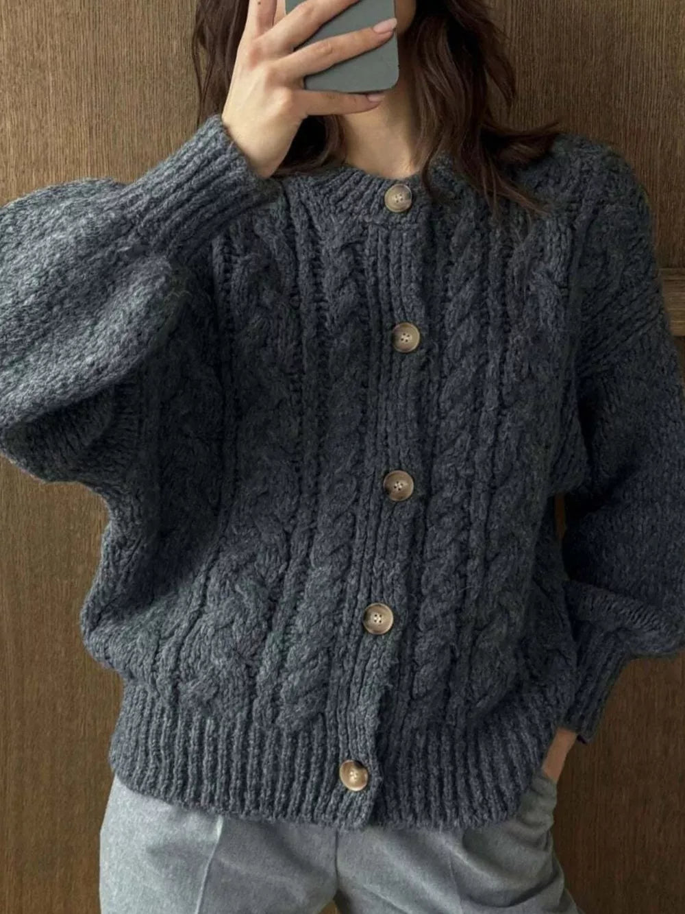 Gray cable-knit button-down cardigan with crew neck and balloon sleeves.