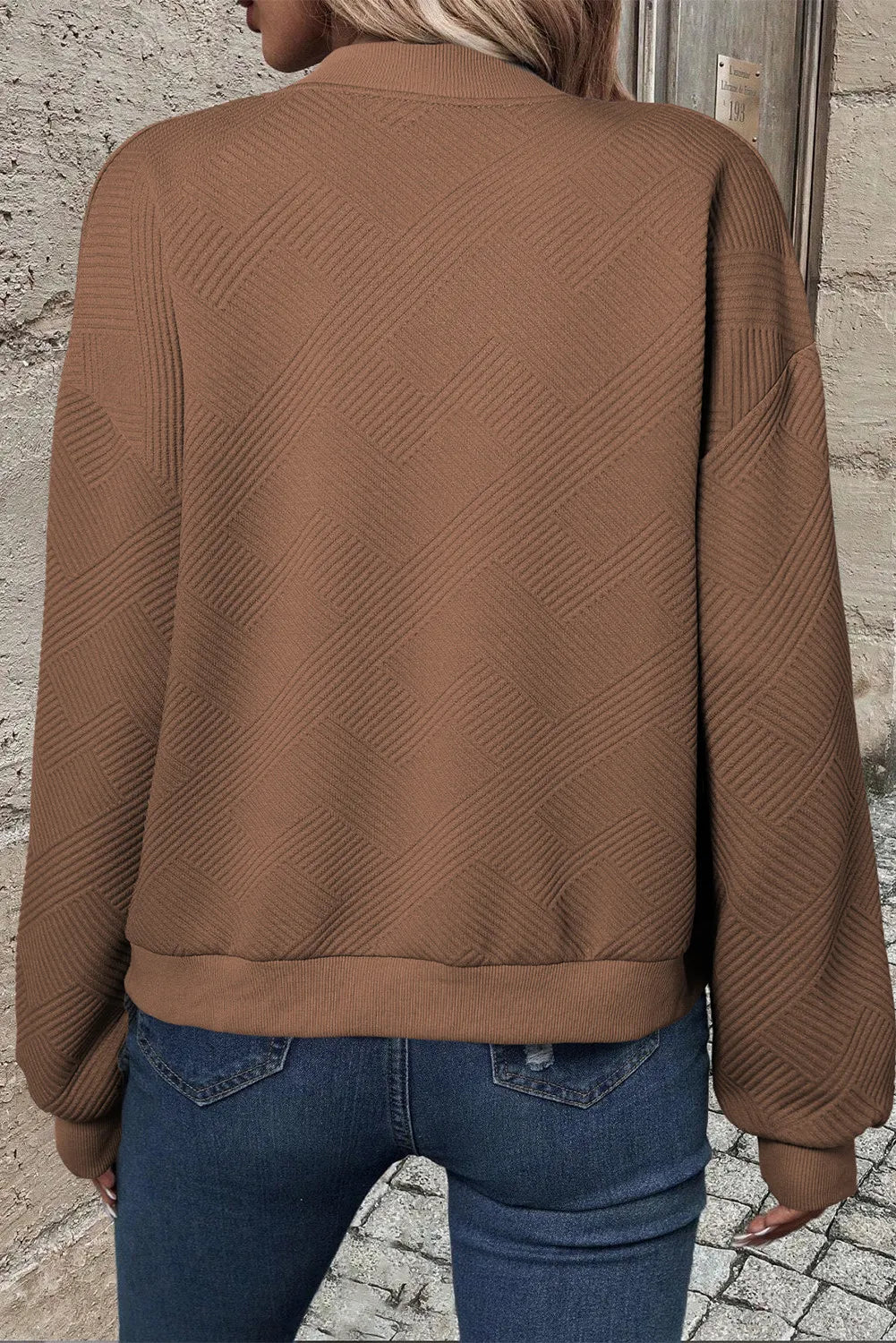 Brown quilted bomber jacket with geometric texture and ribbed cuffs and hem