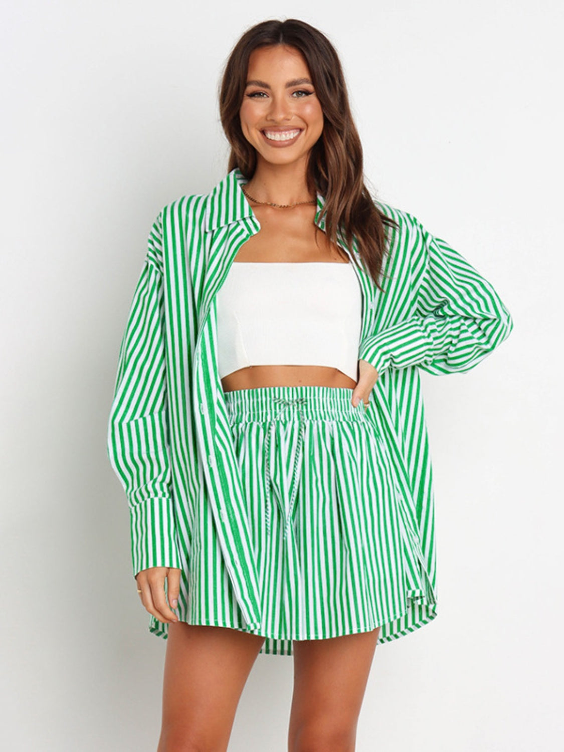 Green and white striped oversized shirting set with drawstring shorts, styled with a white tube top.