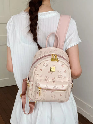 Blush pink mini backpack with allover cat print and gold hardware.